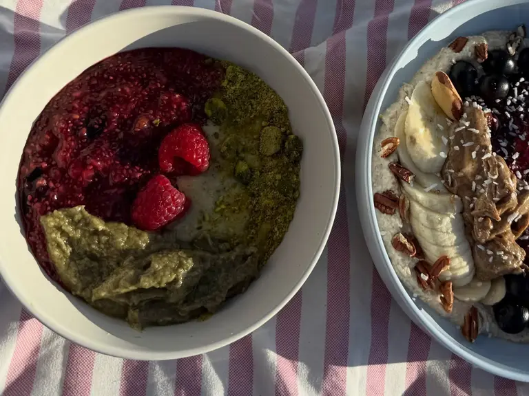 Two Sante Organics bowls seen from above on a striped towel: the Pistachio Addiction Bowl and an early Sante Bowl